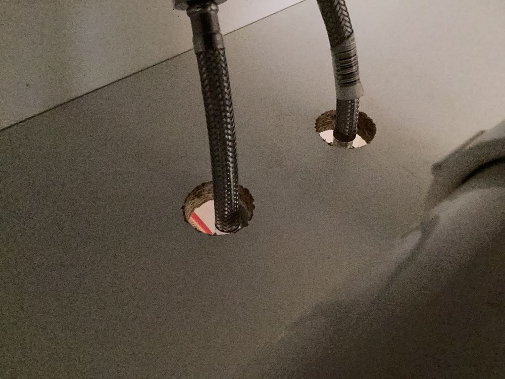 Cover plates missing where plumbing pipes pass through cabinets, leaving pest entry points, Wollert
