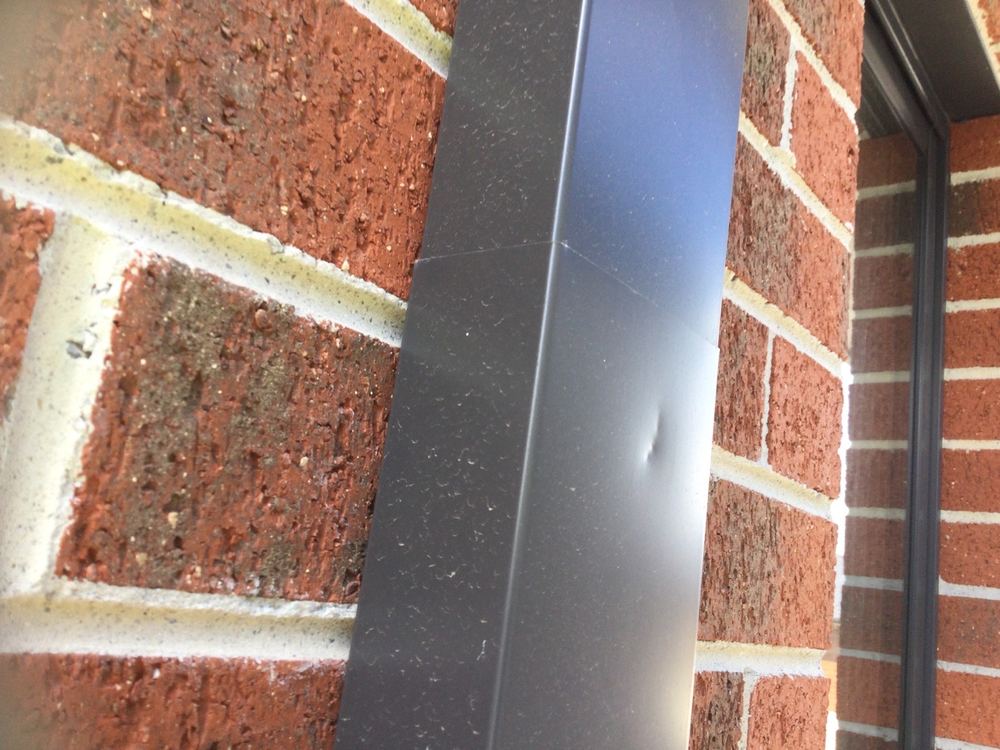 Metal downpipe dented or scratched, which can lead to early corrosion, Wollert