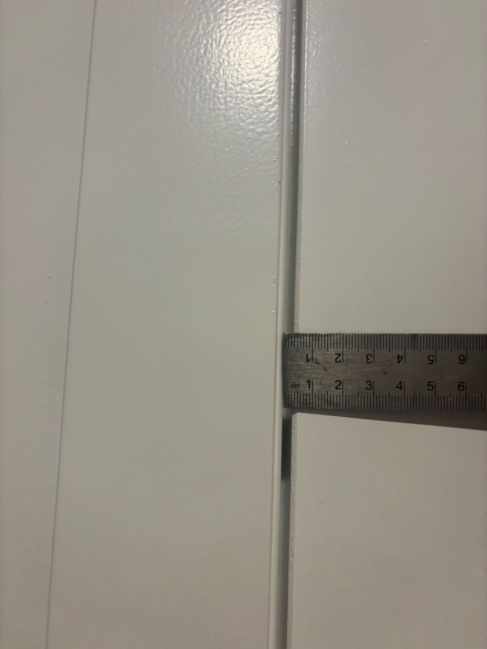 Uneven gap between the door and its frame, needing adjustment, found during a fixing inspection in Wollert