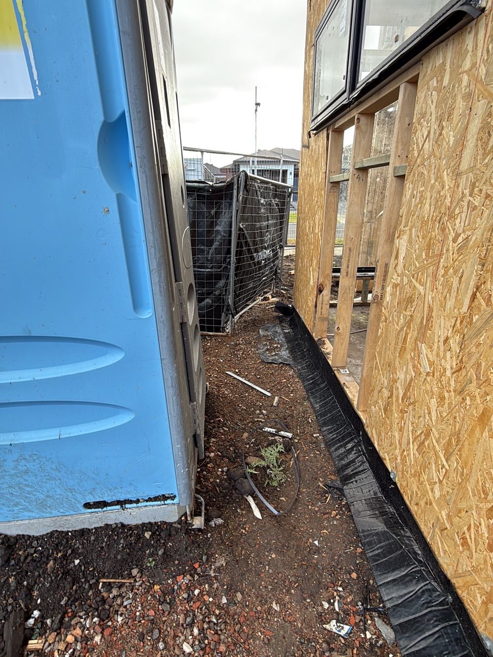 Site not graded, so rainwater can run back and seep under the slab, Wollert