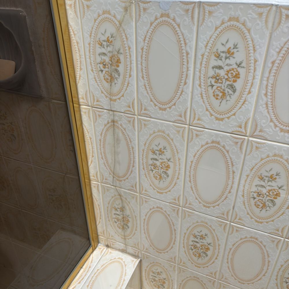 Floor or wall tile cracked and broken, found during a building and pest inspection in Epping